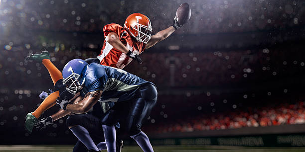 American football player in action on stadium American football player in action on the . stadium american football player stock pictures, royalty-free photos & images