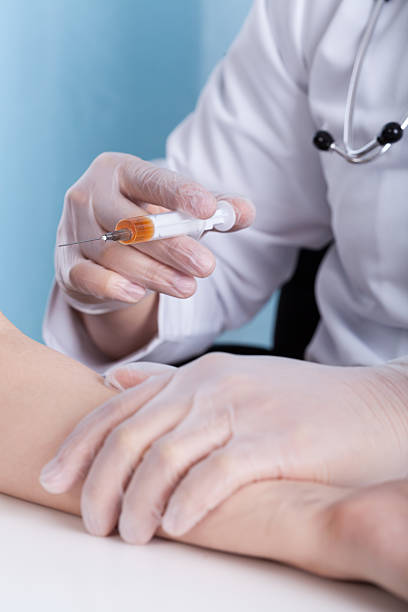 istock Close-up of doctor's hand with syringe 525858047