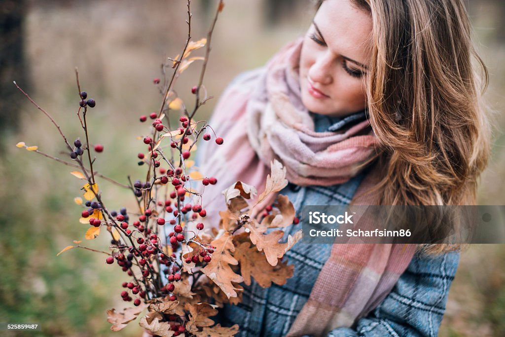 Happy beautiful girl in the park beautiful girl walking in autumn park, a bouquet of bright leaves and berries, looks at the bouquet Adolescence Stock Photo