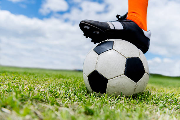 istock Football player with a ball 525860025