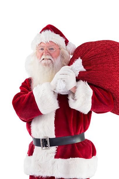 istock Santa carries his red bag and smiles 525860437