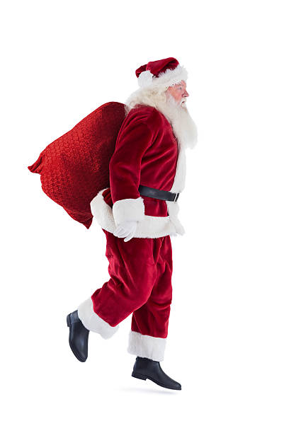 istock Santa jumps with his bag 525861149