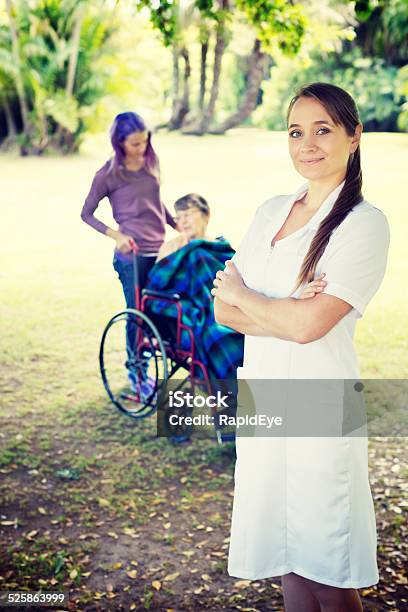 Smiling Nurse Enjoys Outing For Elderly Patient And Young Friend Stock Photo - Download Image Now