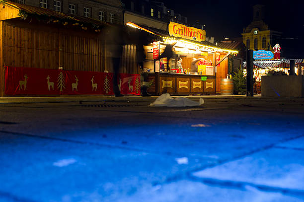 Bayreuth, Bavaria, Germany - November 28, 2014: It´s the first day of Christmas Market in Bayreuth. The market is located at midtown (Maximilianstraße). A lot of stallholders are closing her stalls at 7:30 PM.