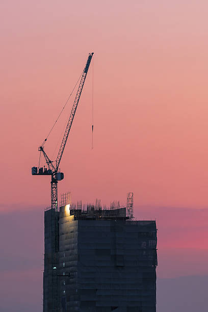 istock Industrial crane at construction site with sunset sky background 525875462