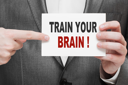 Train Your Brain. Card in businessman hand