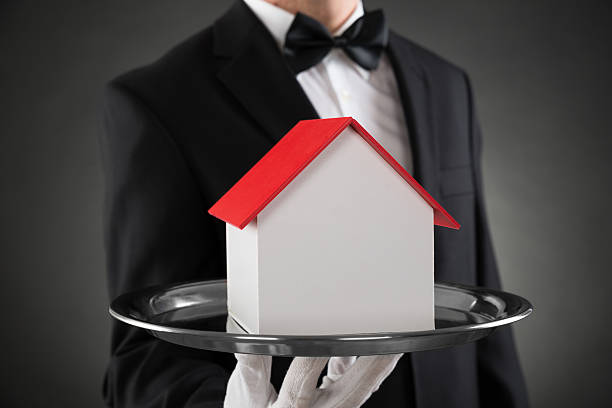 istock Close-up Of Butler With House Model 525876992