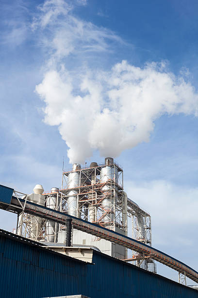 istock Industrial smoke from chimney on blue sky 525877642