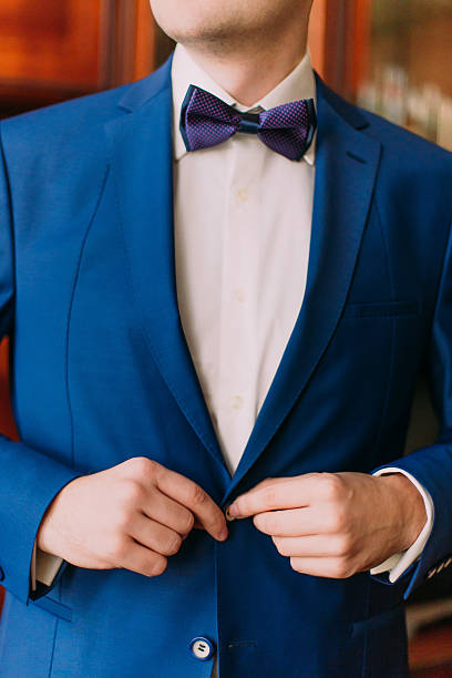 istock Close-up adult solid man button his blue suit near 525878154