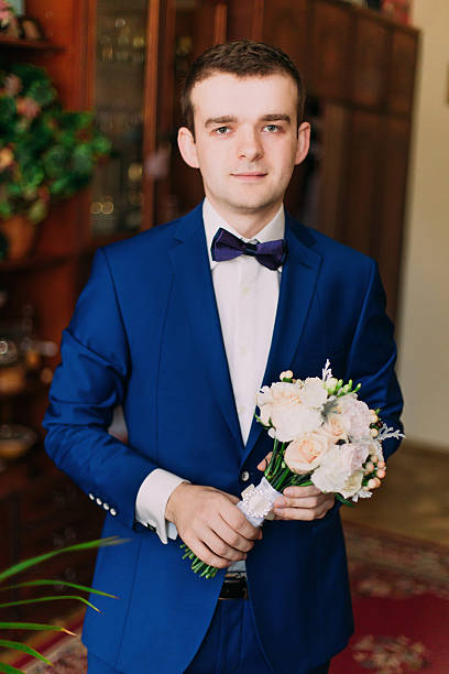 istock Cute stylish groom in blue suit and bow tie with 525878216