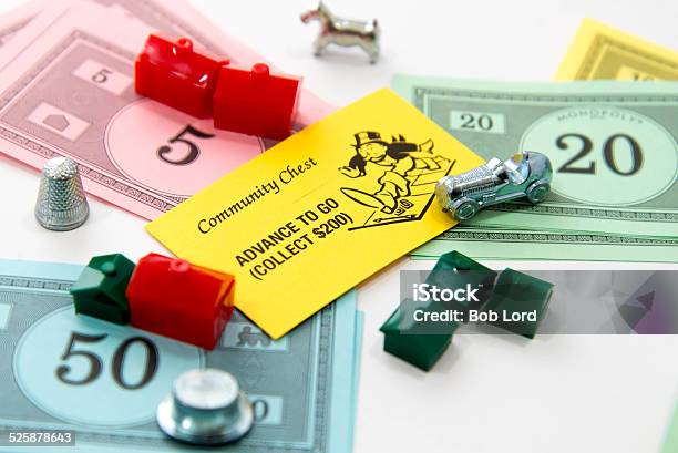 Monopoly Advance To Go Card Money Playing Pieces Stock Photo - Download Image Now