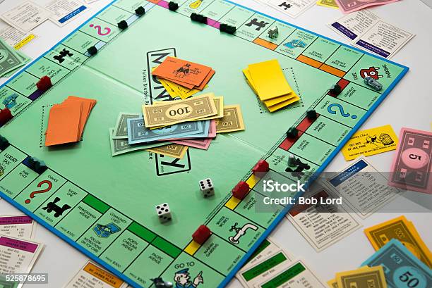 Monopoly Game In Play Money Dice Pieces And Cards Stockfoto en meer beelden van Monopoly - Board Game