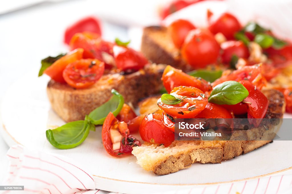 Italian food. Bruschetta. Delicious Italian bruschetta with cherry tomatoes, basil and garlic. Bruschetta Stock Photo