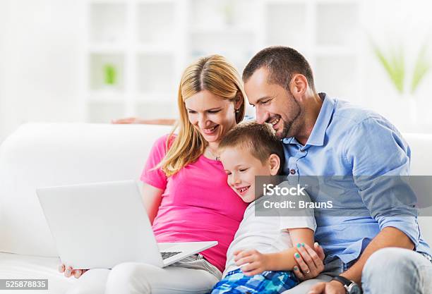 Family Using Laptop Stock Photo - Download Image Now - 30-39 Years, Adult, Boys