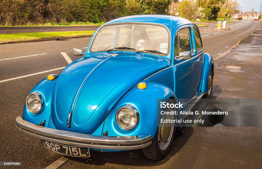 Blue classic car Beetle Warwickshire, United Kingdom - April 7, 2016: Blue classic car Volkswagen Beetle parked at the street as seen from the front. Volkswagen Beetle Stock Photo