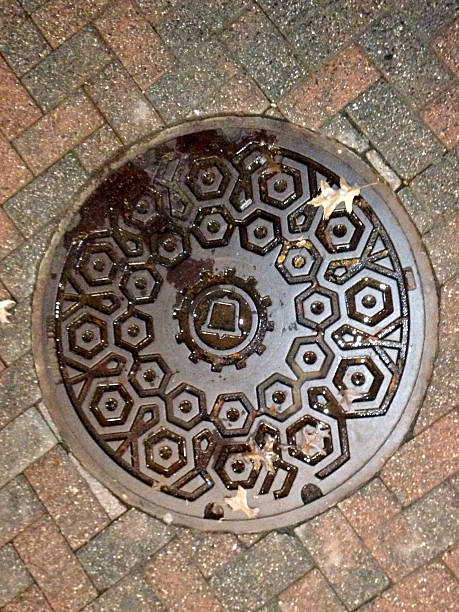 istock Manhole cover with phone icon on bricks 525879881