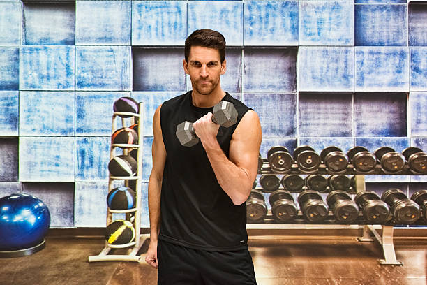istock Muscular man exercising with dumbbells 525880506