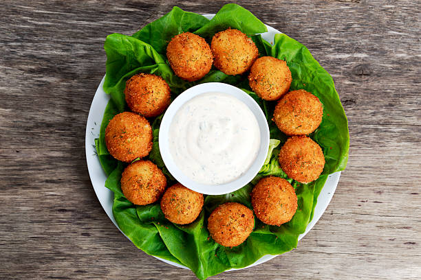 istock Fried mozzarella cheese stick balls with white sauce 525880864