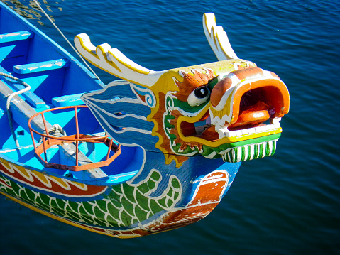 A decorative boat figurehead in the style of a Chinese Traditional Dragon on the Sea.