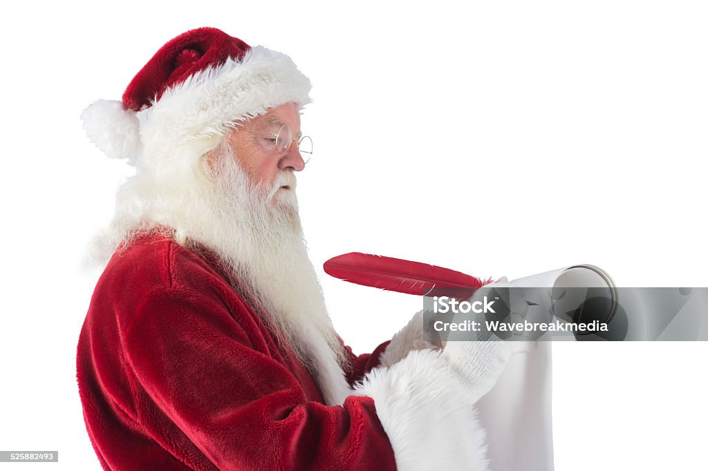 Father Christmas writes a list Father Christmas writes a list on white background 80-89 Years Stock Photo