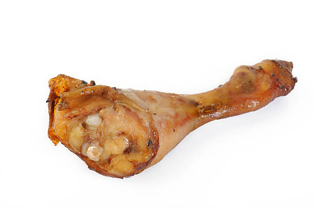 istock Baked chicken drumstick on white background 525883610