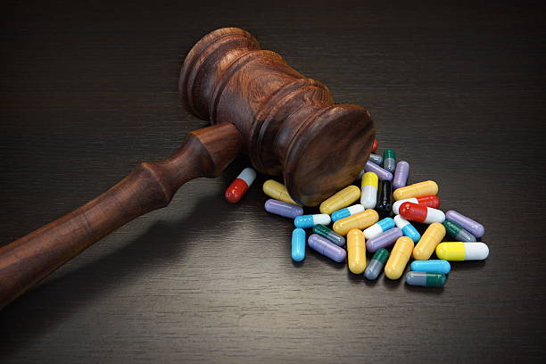 istock Judges Gavel And Medication On Black Wood Grunge Background 525883642