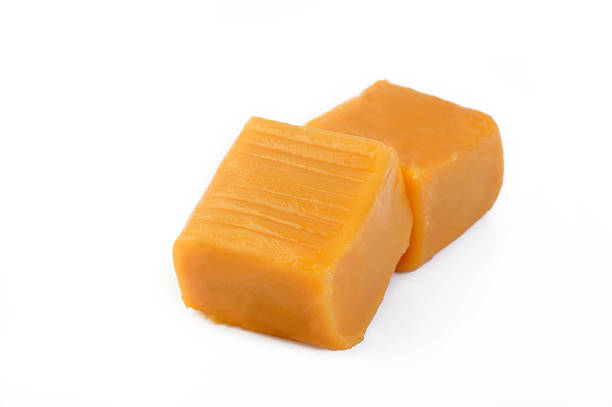 istock Caramel sweet candies on white background 525883680