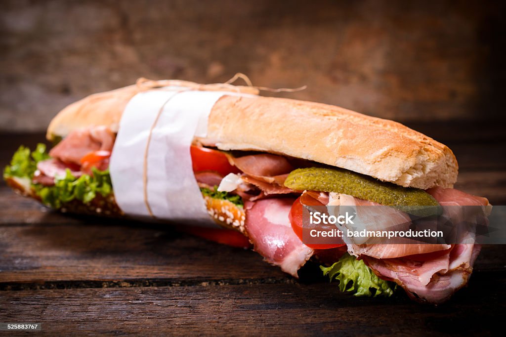 Long sandwich Long bun sandwich with prosciutto and vegetables,selective focus Adulation Stock Photo