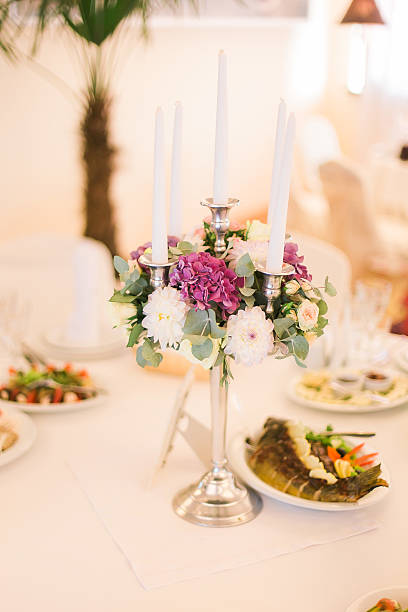istock Festive wedding table setting with pink flowers, glasses and candles 525883972