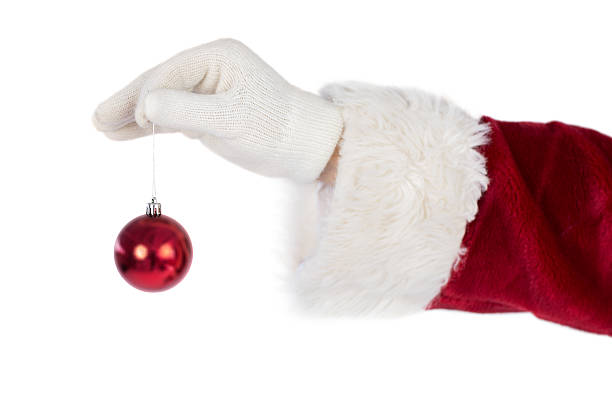 istock Santas hand is holding a Christmas bulb 525884479