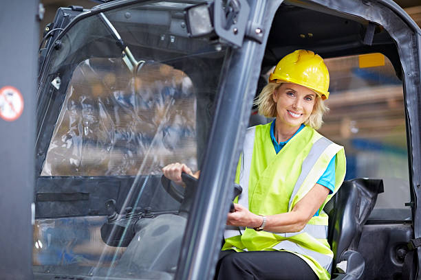 istock Woman driving a forklift at distribution warehouse 525884559