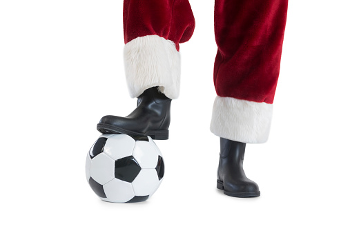 Santa Claus is playing soccer on white background