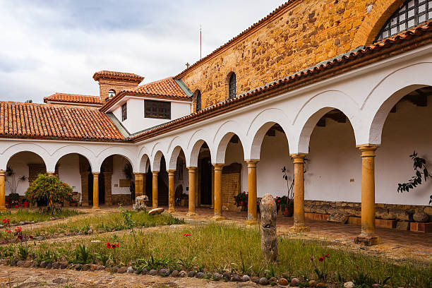 Looking from the courtyard of the Monastry of Santo Ecce Homo towards at the arches that surround the courtyard. The monastary was founded in 1620; the church to the right, was completed in 1661. The building is a good example of classic colonial Spanish architecture. In 1998 the buildings were declared as national archtictural heritage. Photos are permitted in every area of the premises.  Photo shot in the midday light on a cloudy day; horizontal format. No people.