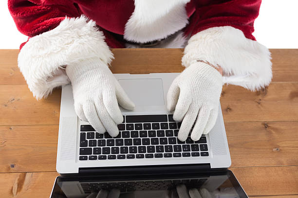 istock Santa is writing something on his laptop 525885049
