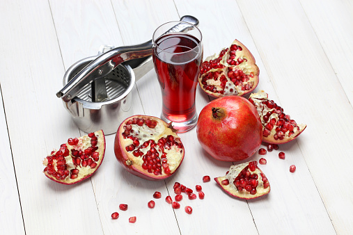 pomegranate fruits, pomegranate juice and juice press