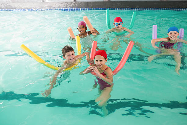 istock Cute little kids in the swimming pool 525886185