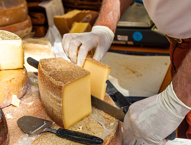 istock Man cutting piece of cheese 525893587