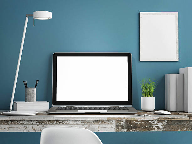istock Laptop on wooden table, Blue wall painted 525894417