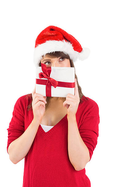 istock Festive young woman holding a gift 525894467