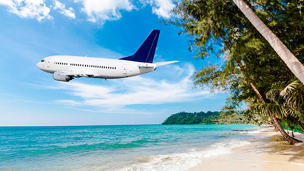 istock Jet plane over the tropical sea 525895031