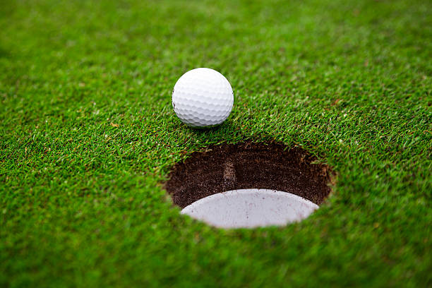 istock Golf ball on green meadow. 525895567