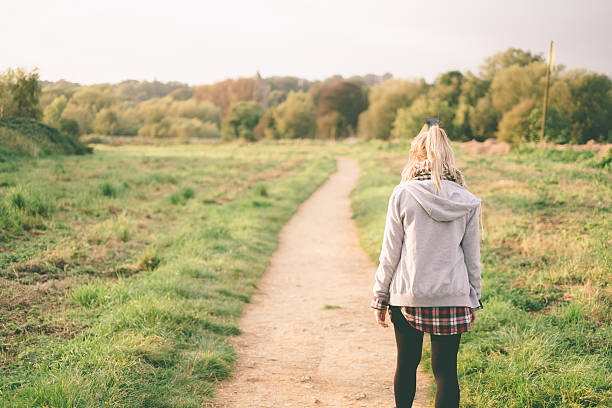 istock Girl walking through meadow 525897719
