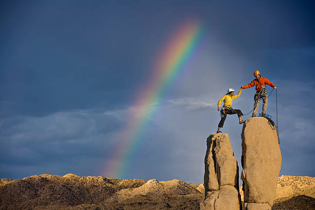 istock Husband and wife climbing team on the summit. 525901275