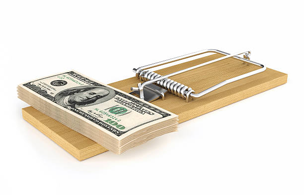 istock Money in a mousetrap 525913047