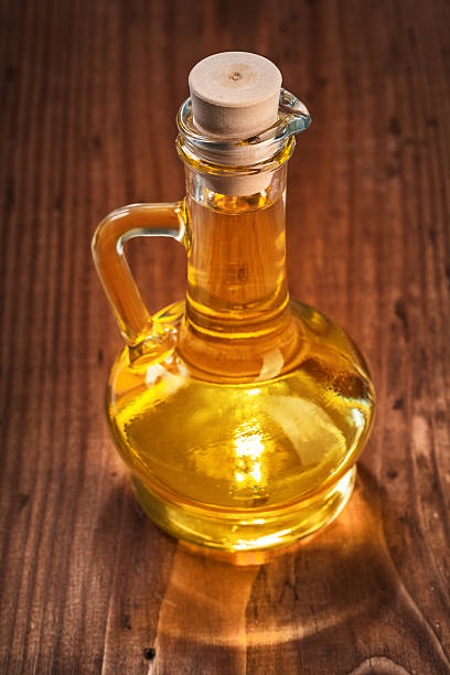 small bootle of olive oil on old wooden board