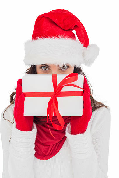 istock Brunette in red gloves and santa hat showing gift 525914195