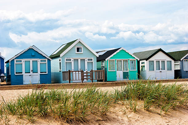 istock Pastel  beach huts on sandy dunes on English coast 525915121