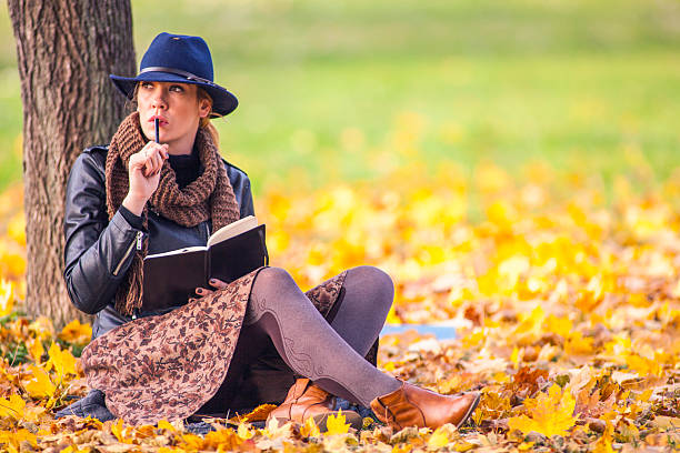 istock Portrait of young female student writes and learns outside 525915507