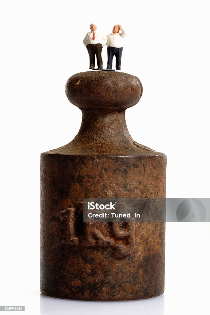 figurines standing on top of weight Abdomen Stock Photo