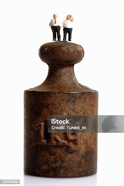 Figurines Standing On Top Of Weight Stock Photo - Download Image Now - Abdomen, Abundance, Adult